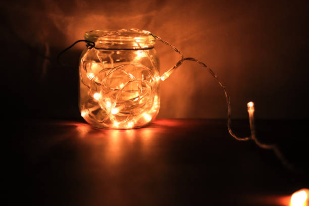 istock Transparent jar with led lights inside and Bokeh lights in background. Home decoration 1297942774