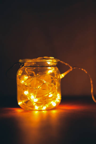 istock Transparent jar with led lights inside and Bokeh lights in background. Home decoration 1297942789