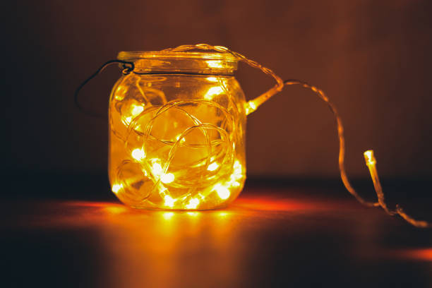istock Transparent jar with led lights inside and Bokeh lights in background. Home decoration 1297942795