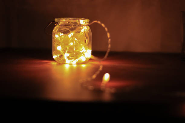 istock Transparent jar with led lights inside and Bokeh lights in background. Home decoration 1297942797