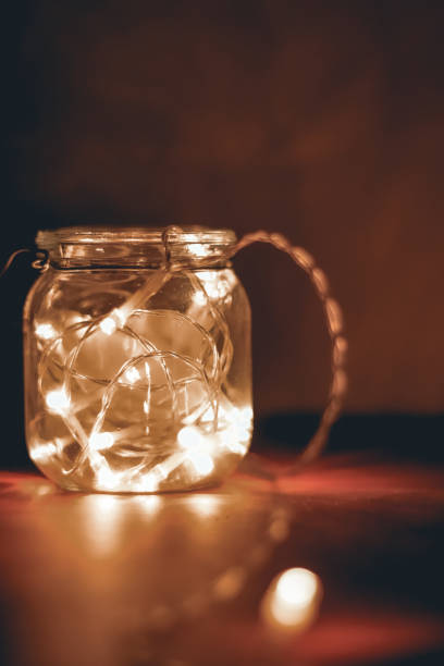 istock Transparent jar with led lights inside and Bokeh lights in background. Home decoration 1297942799