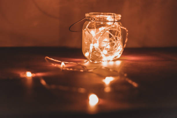 istock Transparent jar with led lights inside and Bokeh lights in background. Home decoration 1297942802