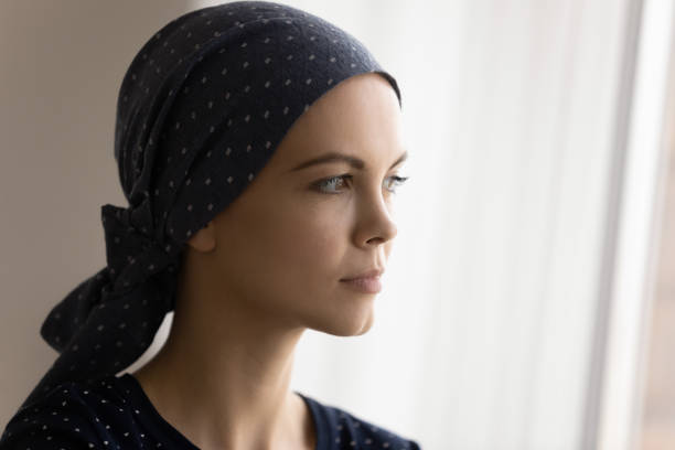 istock Lady in head scarf struggle with cancer plan future life 1297947209