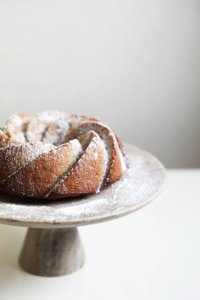 istock Homemade bundt cake with powder sugar on a white table. 1297947434
