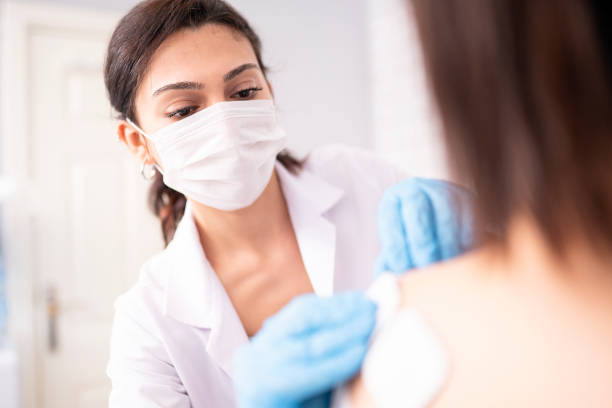 istock Female physiotherapist is examining to her patient. 1297947885