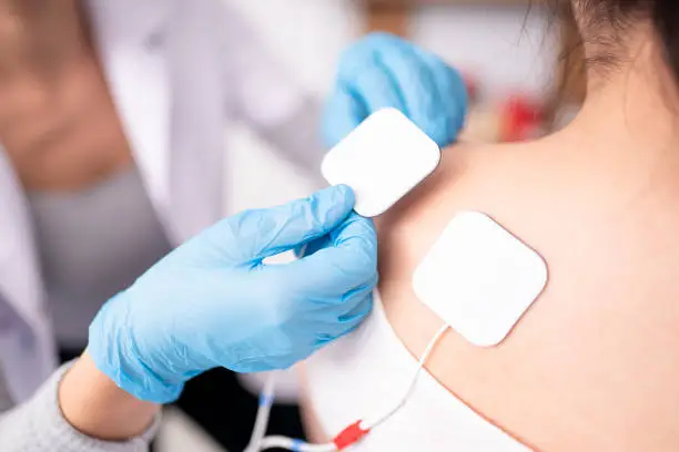 Photo of Female physiotherapist is examining to her patient.