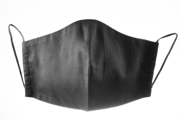 istock Face protective mask on white background. Black reusable face mask. Antivirus mask made from black cotton. Isolated 1297948971