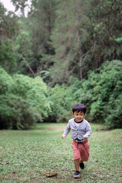istock Adorable kid with a green forest background 1297949334