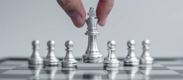istock silver Chess King figure Stand out from the crowd on Chessboard background. Strategy, leadership, business, teamwork, different, Unique and Human resource management concept 1297953170