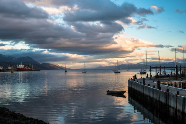 USHUAIA, ARGENTINA - april 04. 2018: Ships at the Port of Ushuaia, the capital of Tierra del Fuego, next to the little harbor town. Ushuaia is the southernmost city in the world
