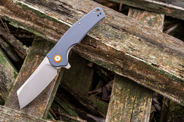 istock Rough knife with a thick knife blade. Knife with a tanto blade on a tree. 1297954898