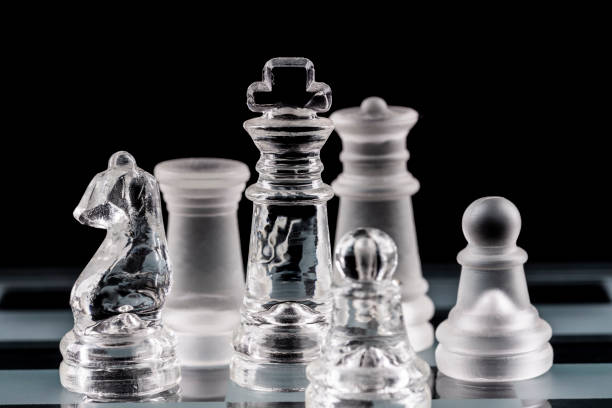 istock Glass chess pieces on a glass chessboard 1297955789