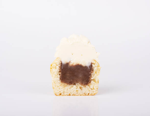 istock The cupcake is cut in half, with a chocolate filling and white vanilla icing 1297959460