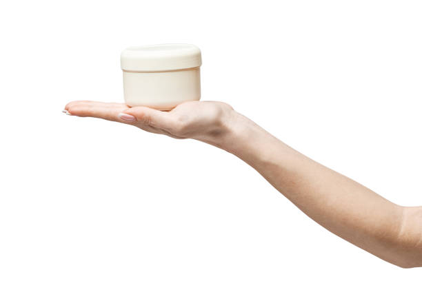 istock hand holding plastic can of cream Isolated on a white background 1297960630