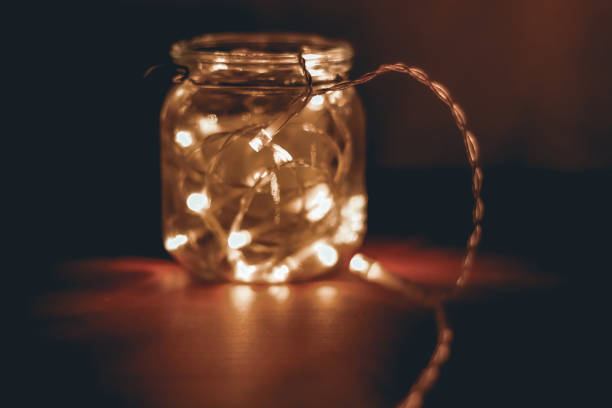 istock Transparent jar with led lights inside and Bokeh lights in background. Home decoration 1297961134