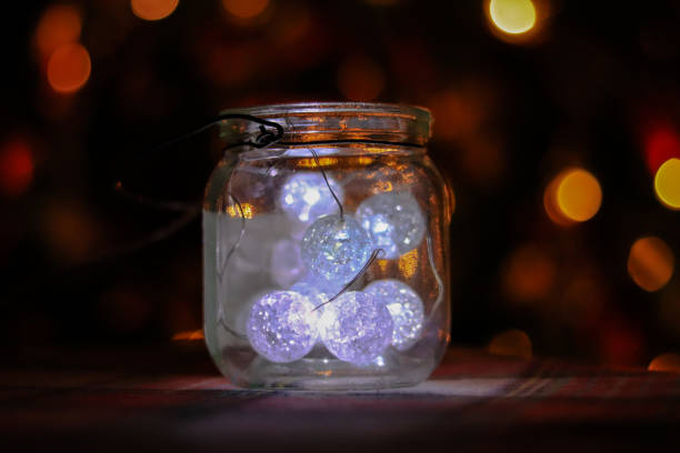 istock Transparent jar with led lights inside and Bokeh lights in background. Home decoration 1297962362