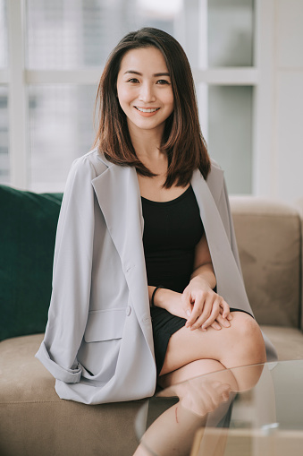 asian chinese beautiful businesswoman looking at camera smiling with confidence