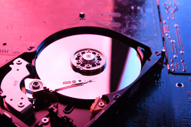 istock Computer Hard disk drives HDD , SSD on circuit board ,motherboard background. Close-up. With red-blue lighting 1297963608
