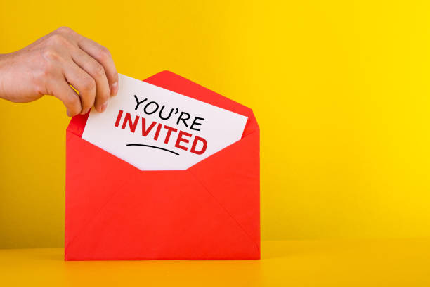 You're Invited Concepts - Hand holding a a card with red envelope. You're Invited Concepts - Hand holding a a card with red envelope. guest stock pictures, royalty-free photos & images