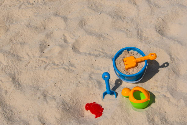 Playing in the sand Plastic beach toys for children on a white sandy beach. sandbox stock pictures, royalty-free photos & images