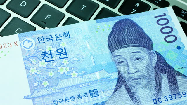 Close up of a rotating South korean won banknote on keyboard, 4k Resolution.