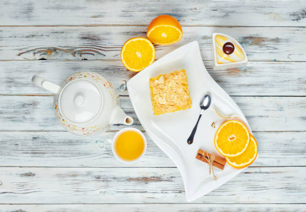 istock Hot tea with a mug spoon oops orange slices and sugar. Cozy home tea concept 1297967913