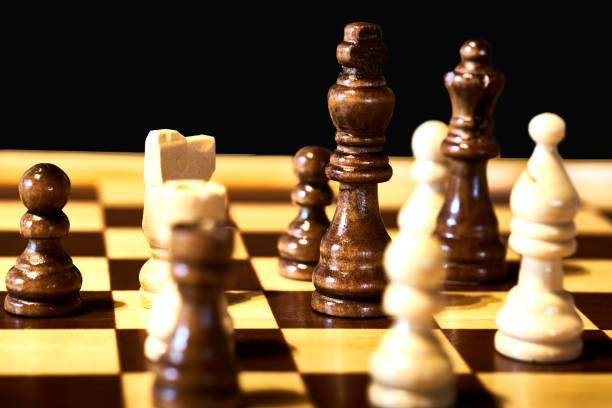 close-up view of a chess game, with selective focus on the black king. - gameplan imagens e fotografias de stock