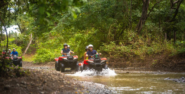 Group of hispanic tourists driving 4x4 vehicles in Costa Rica Group of hispanic tourists driving 4x4 vehicles in Costa Rica quadbike photos stock pictures, royalty-free photos & images