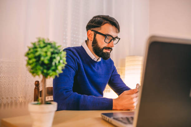 istock Man working late at night home 1297977738