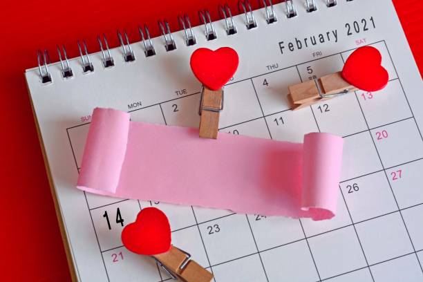 istock Torn paper on February calendar 2021 with red background 1297980515
