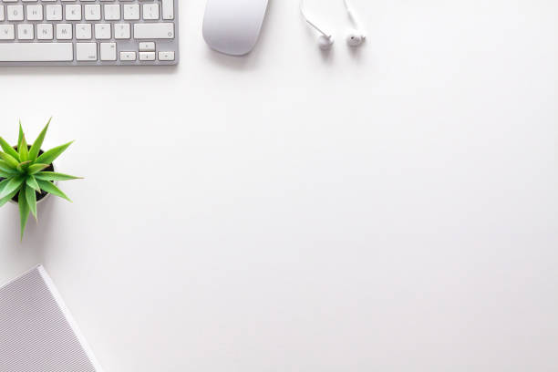 istock Top view of a white office desk. Copy space. White technology. 1297981255