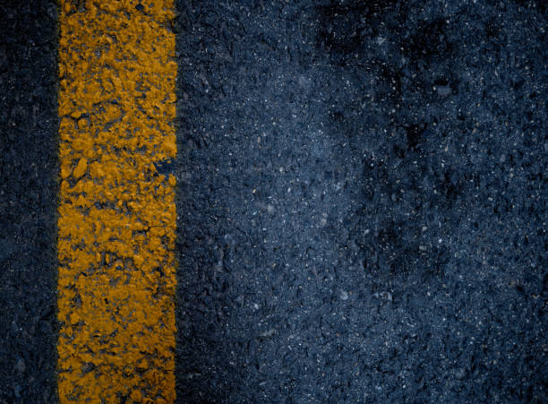 istock yellow traffic line painted on asphalt 1297984261