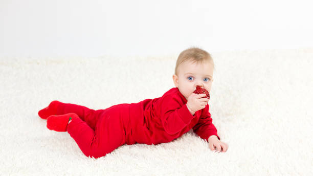 istock A small child lies on his stomach on a white carpet 1297984334