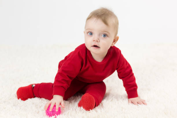 istock Handsome kid playing with toy while sitting on the floor 1297984344