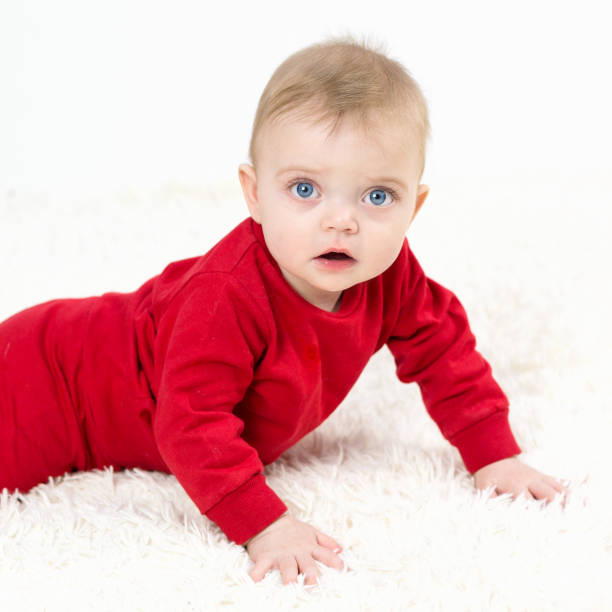 istock A small child lies on his stomach on a white carpet 1297984348