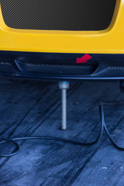 istock Air jack dropping racecars in pit stop. 1297986559