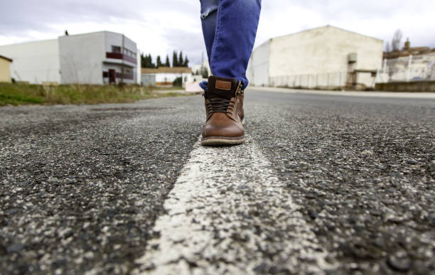 istock Person walking on road line 1297986611