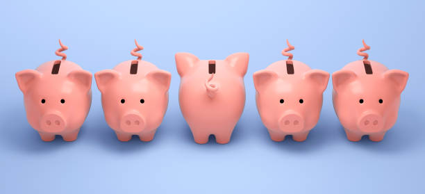 istock Four piggy banks looking forward and one looking back 1297987792