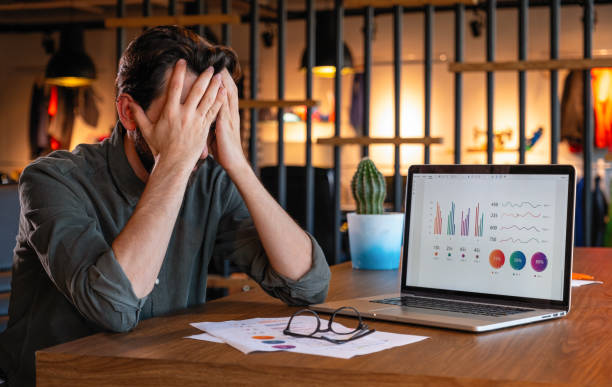 istock Tired businessman sits at the desk 1297988967