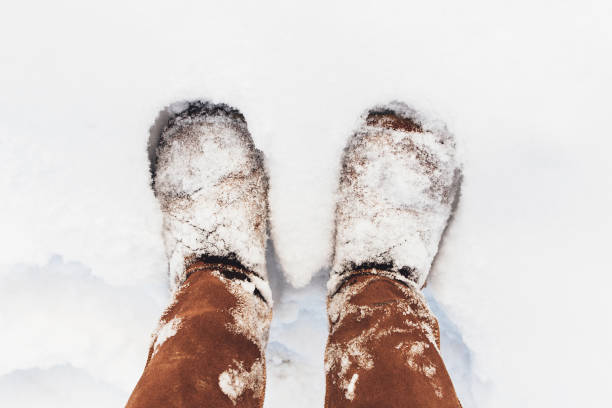 istock Brown boots covered with snow in the winter 1297989546