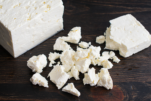 A block of feta cheese that has been broken into small pieces