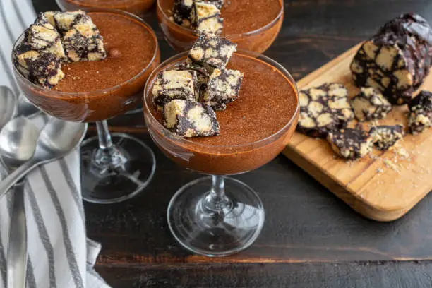 Chocolate mousses topped with chocolate salami and served in a coupe glass