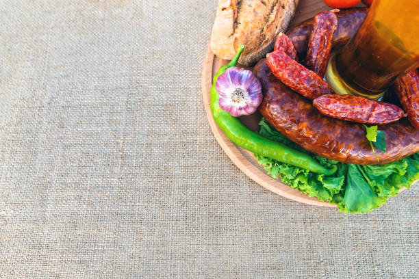 istock beer in a glass, sausage, vegetables on a table 1297995761