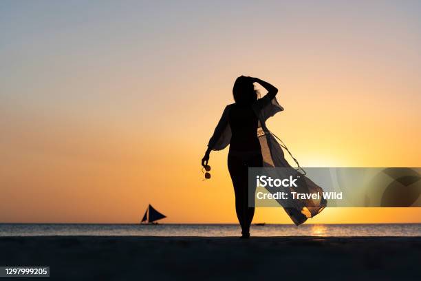 Stunning View Of The Silhouette Of A Girl Walking On A Beach During A Beautiful And Romantic Sunset White Beach Boracay Island Philippines Stock Photo - Download Image Now