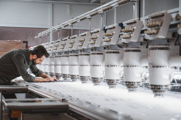 man working in textile embroidery machine - factory garment sewing textile imagens e fotografias de stock
