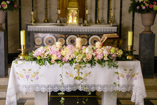 Altar decorated for the wedding ceremony. Flowers in church. Europe