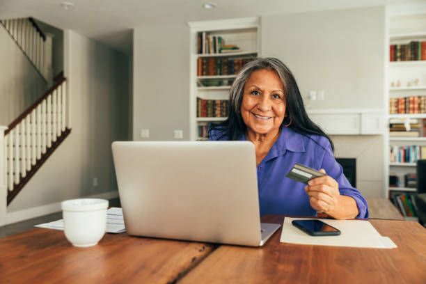 istock Senior Woman Paying Bills and Banking Online 1298002349