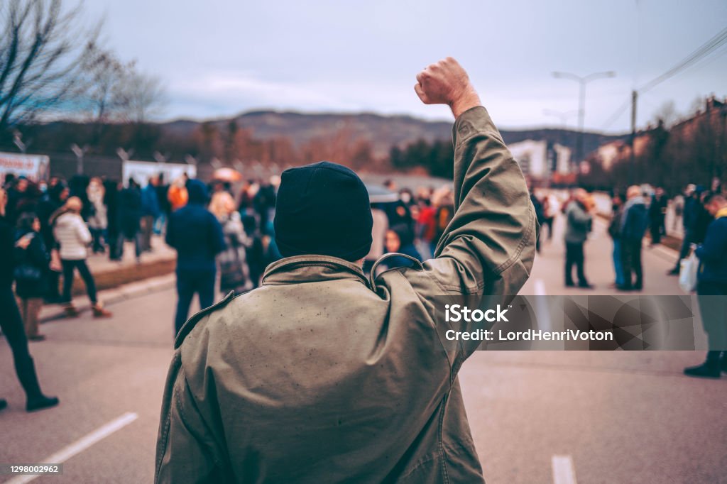 Man protests in the street with raised fist Protest Stock Photo