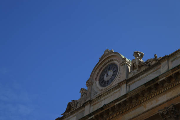 istock clock on a building in Italy against a blue sky 1298003519