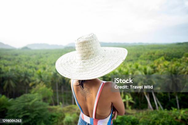 Stunning View Of A Girl With A Large Straw Hat Admiring The Palm Tree Forest Is Siargao Philippines Stock Photo - Download Image Now